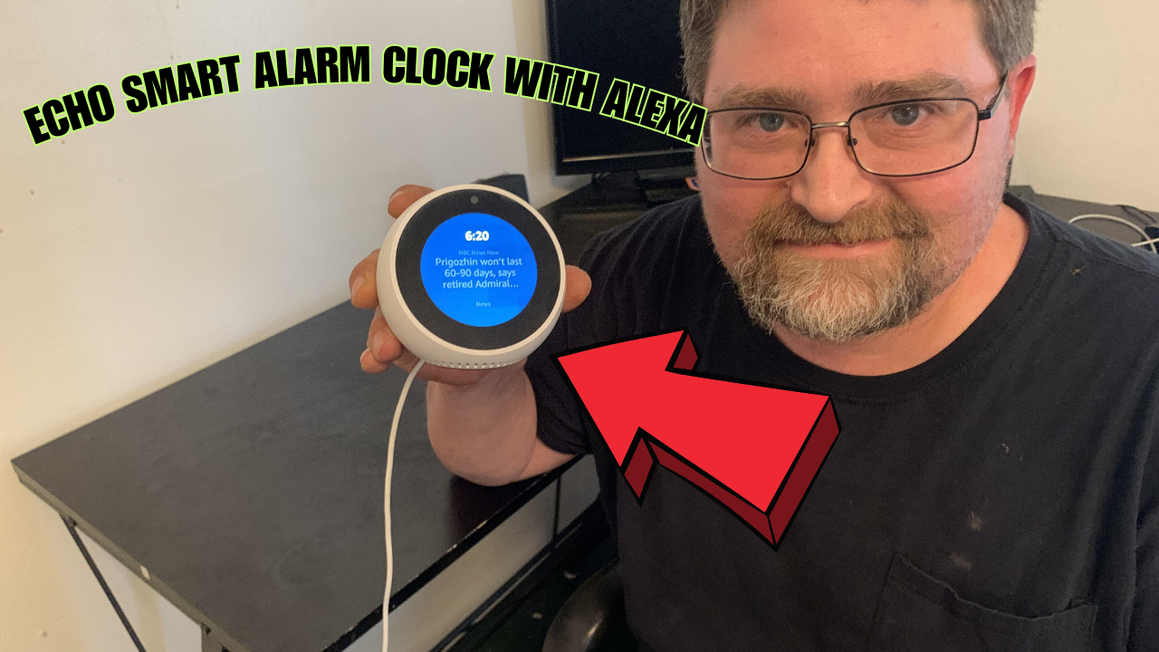 Man holding the Echo Spot Smart Alarm Clock with a red arrow pointing at the clock