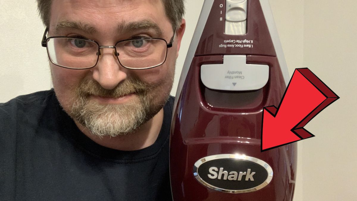 Man showing the Shark Rocket Deluxe Pro Vacuum Cleaner